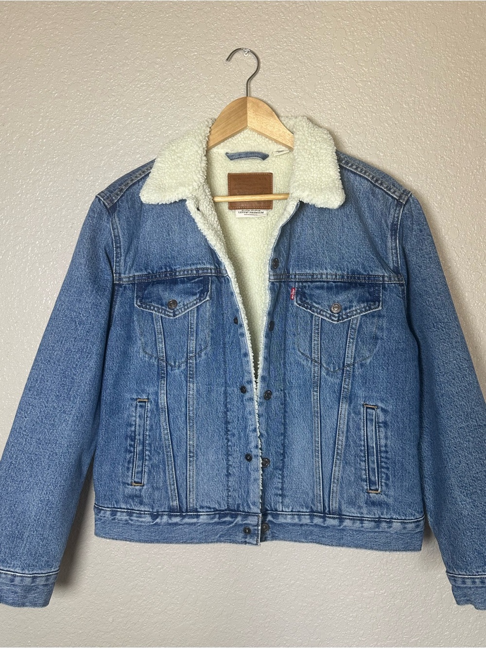 Levi's Sherpa Trucker Jacket with a plush cream lining and color. Medium wash